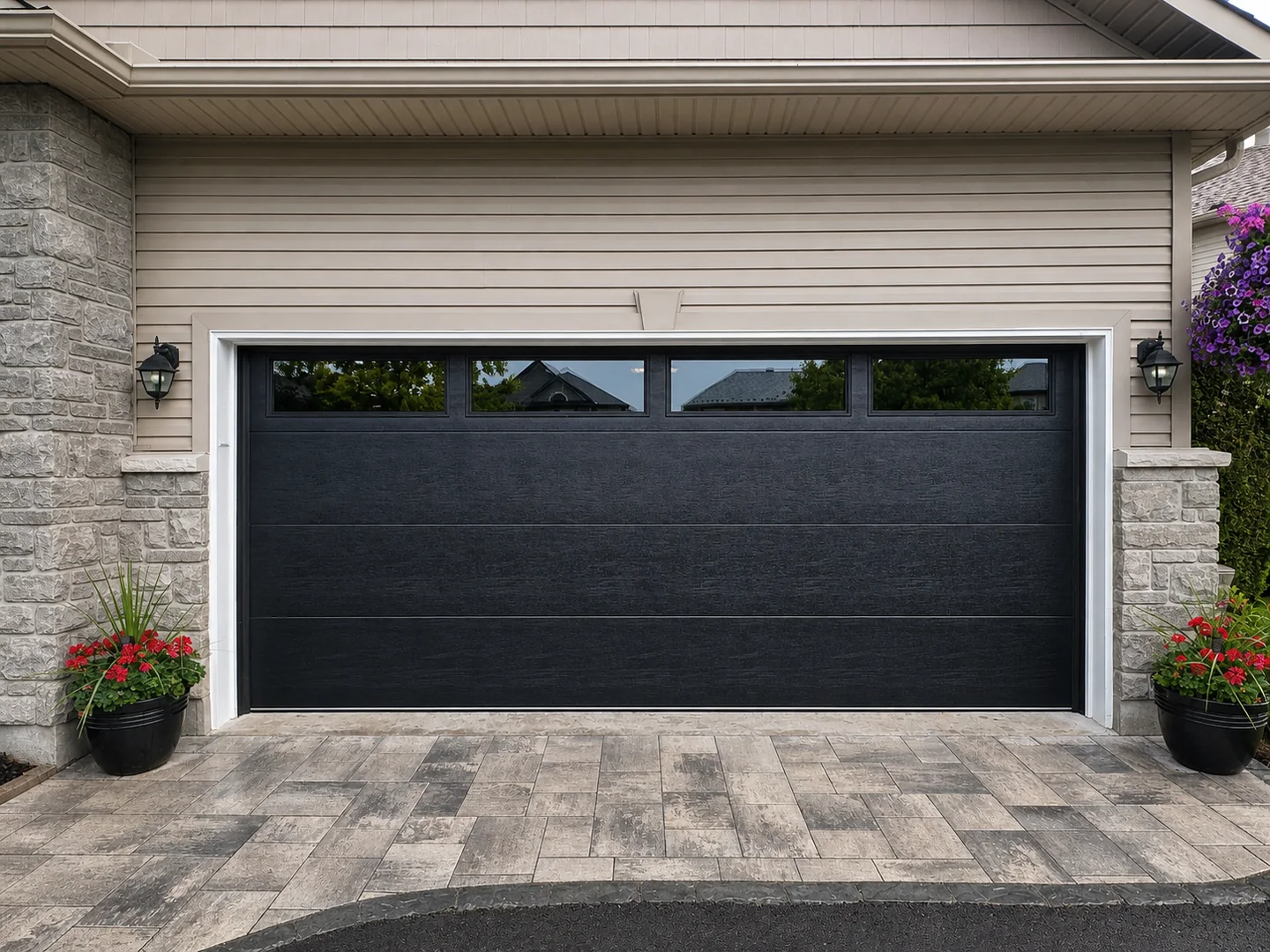 Black garage door with top windows installed on a residential home