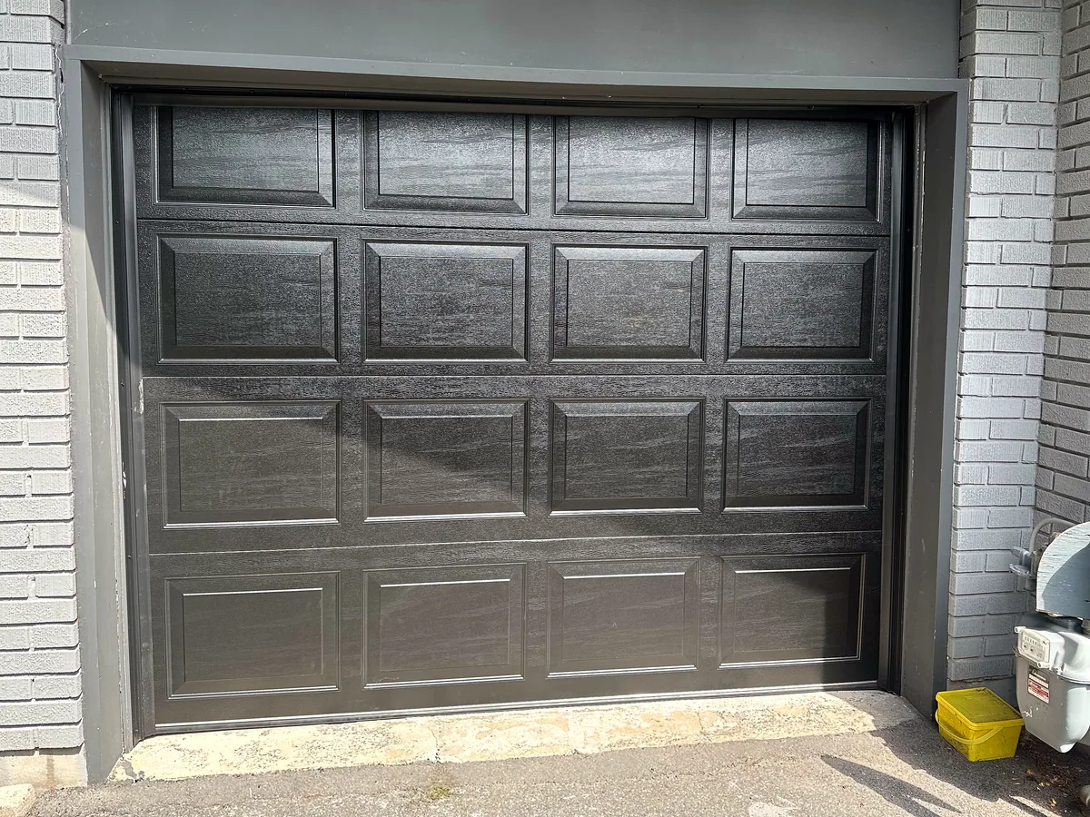 Black raised-panel single garage door
