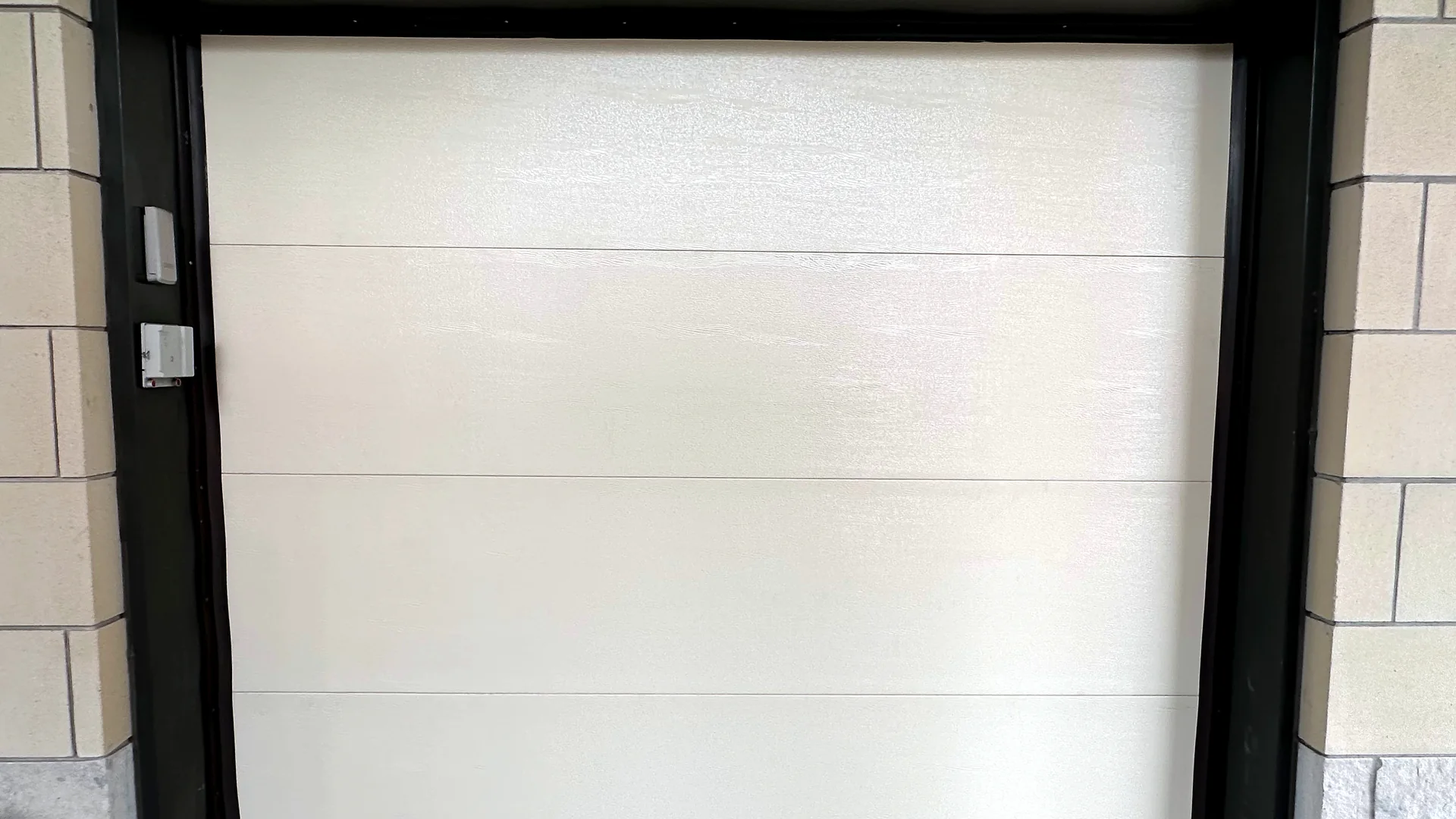 White sectional garage door in a finished residential opening