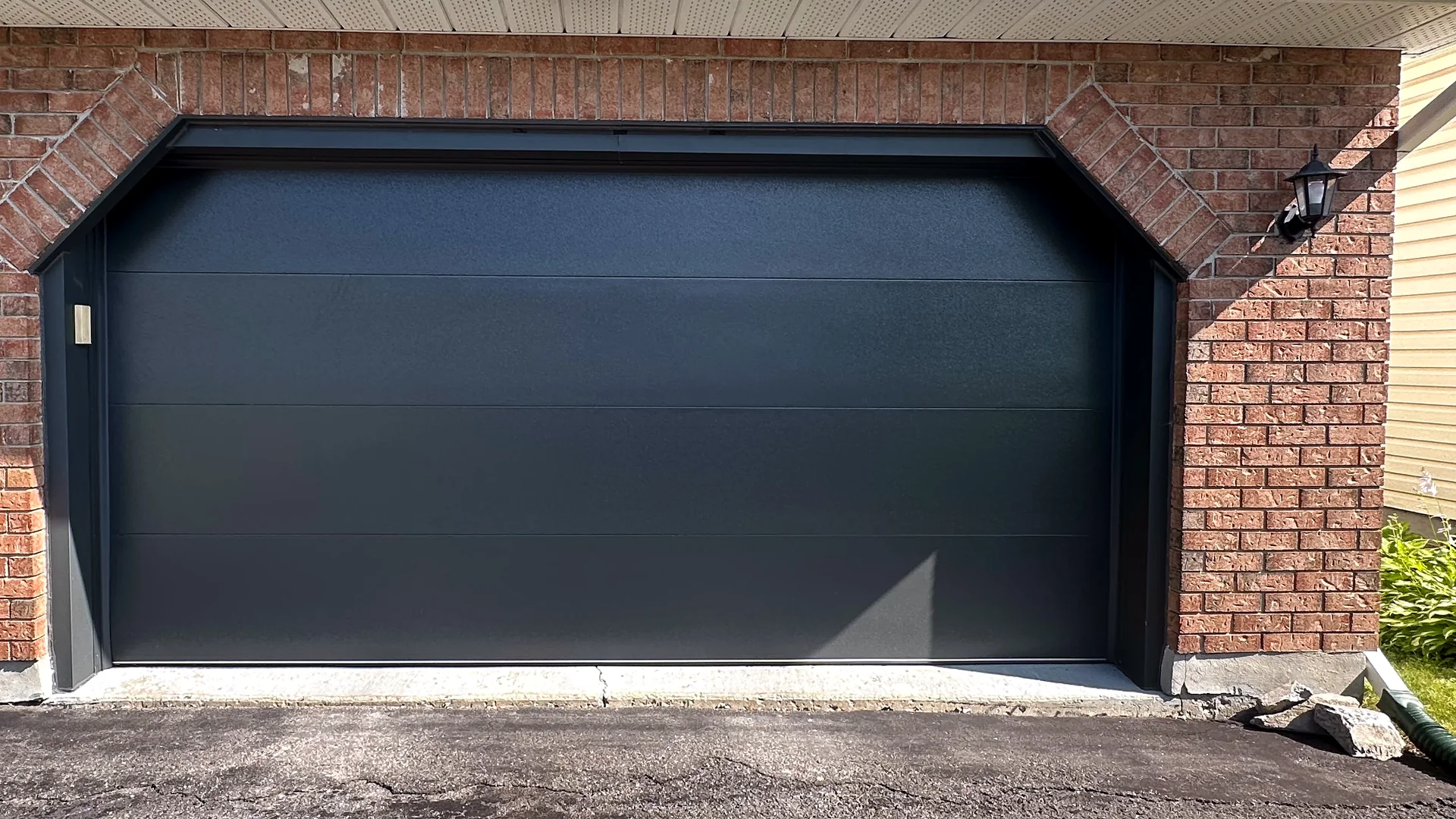 Wide black contemporary garage door for opener installation planning