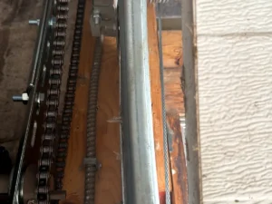 Close view of a residential garage door torsion spring and shaft