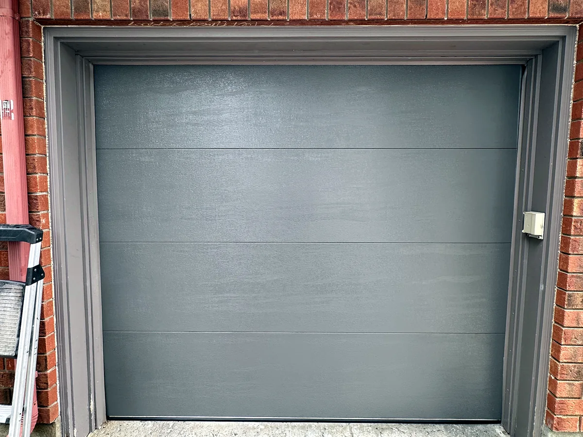 Grey contemporary garage door in a residential opening