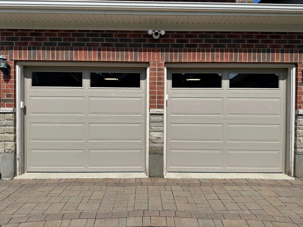 Two matching sectional garage doors with top windows