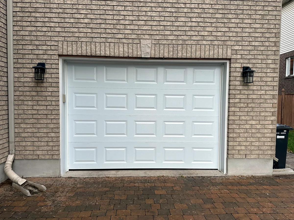 White sectional garage door on a brick home