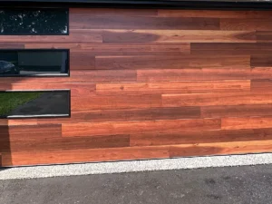 Wood-look sectional garage door with offset rectangular windows