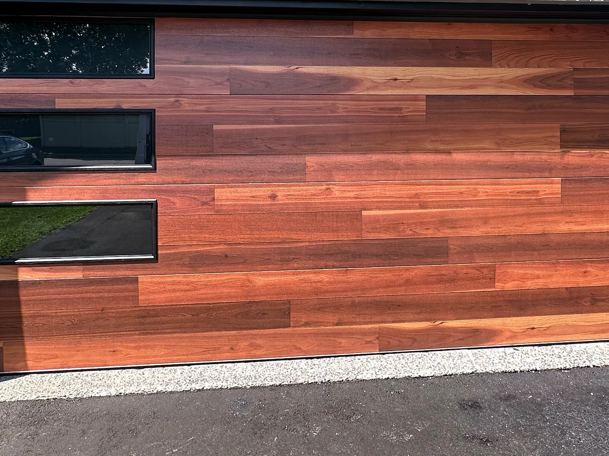 Wood-look sectional garage door with offset rectangular windows