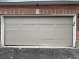 Sandstone Richards-Wilcox recessed smooth ranch garage door on a Calgary brick garage