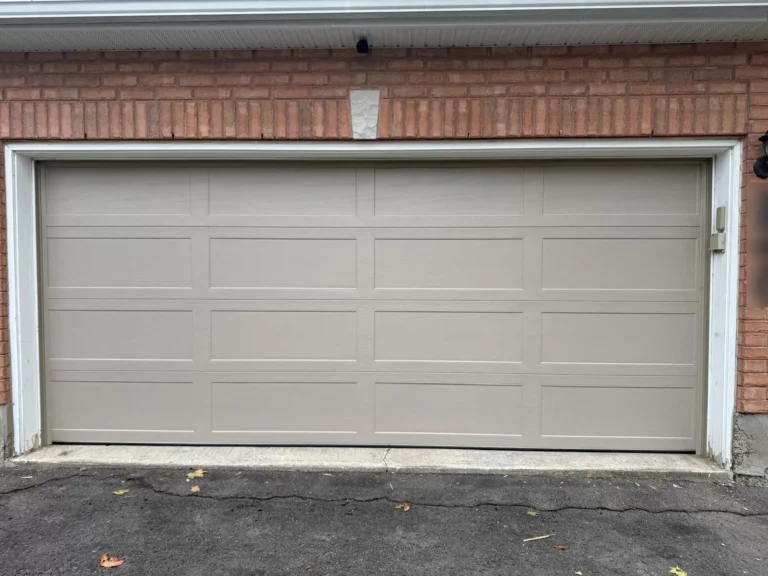 Sandstone Richards-Wilcox recessed smooth ranch garage door on a Calgary brick garage